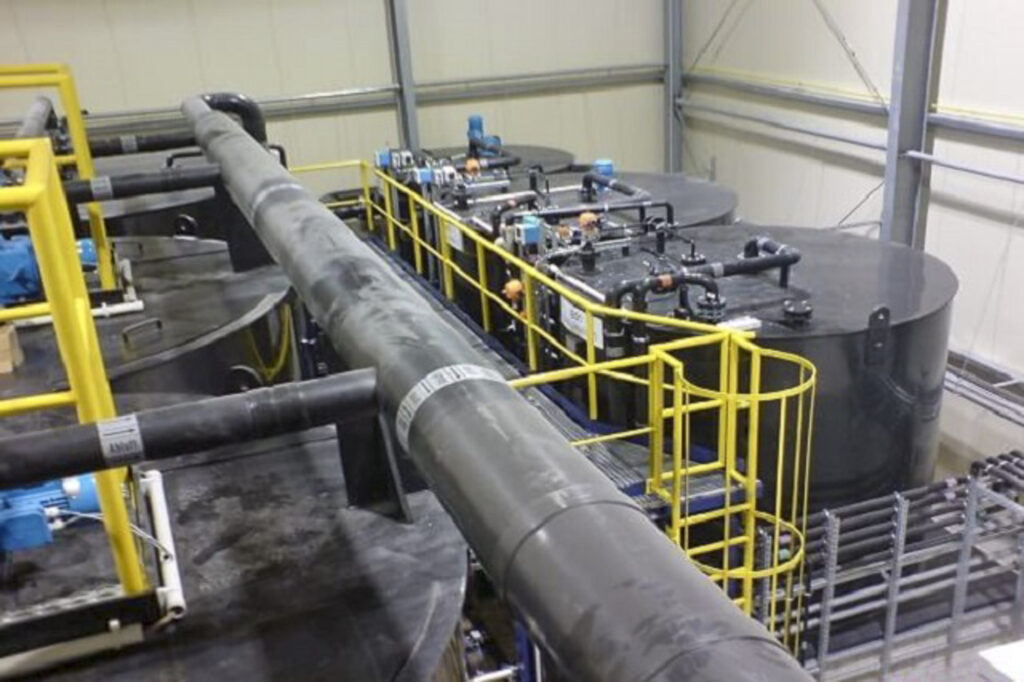 Industriële installatie voor de behandeling van circulatiewater, voorzien van grote tanks en leidingen.