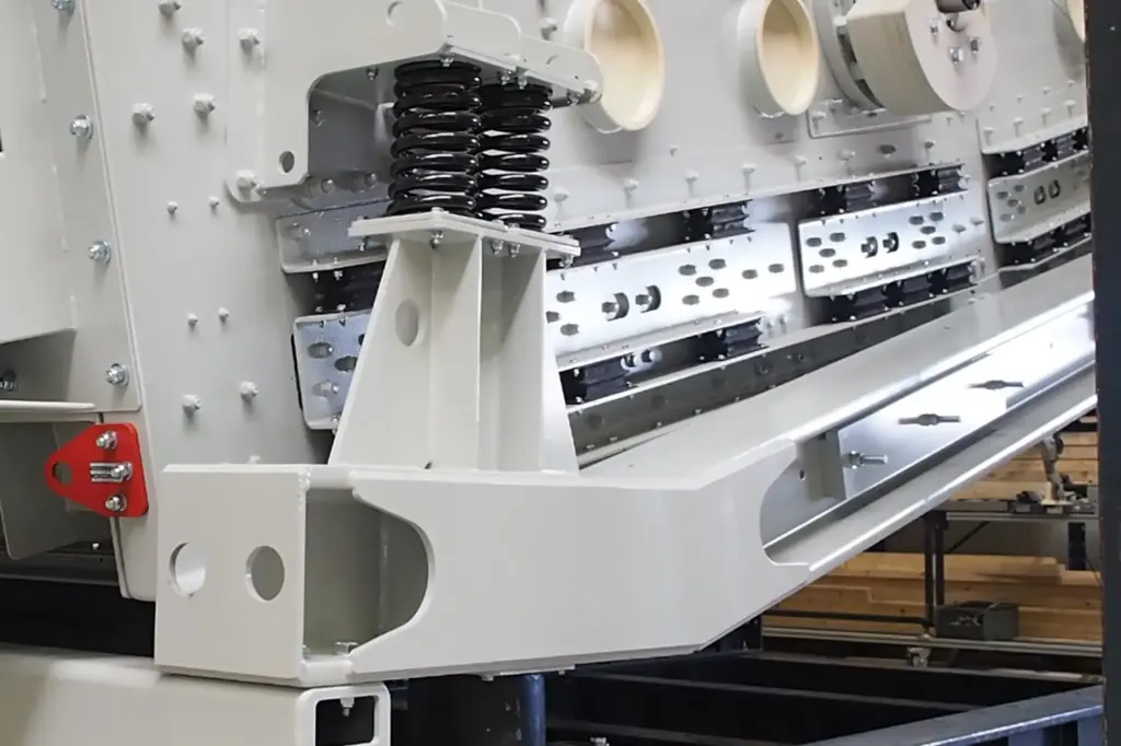 Industriële machine met zichtbare onderdelen en veren.